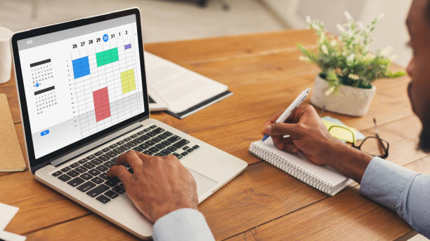 Creative professional organising tasks on a laptop